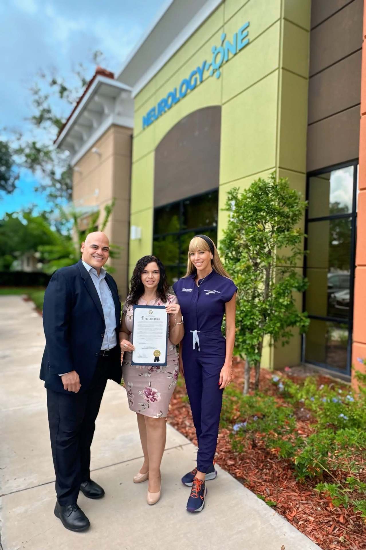 Marthaly presenting a county proclamation at Neurology One