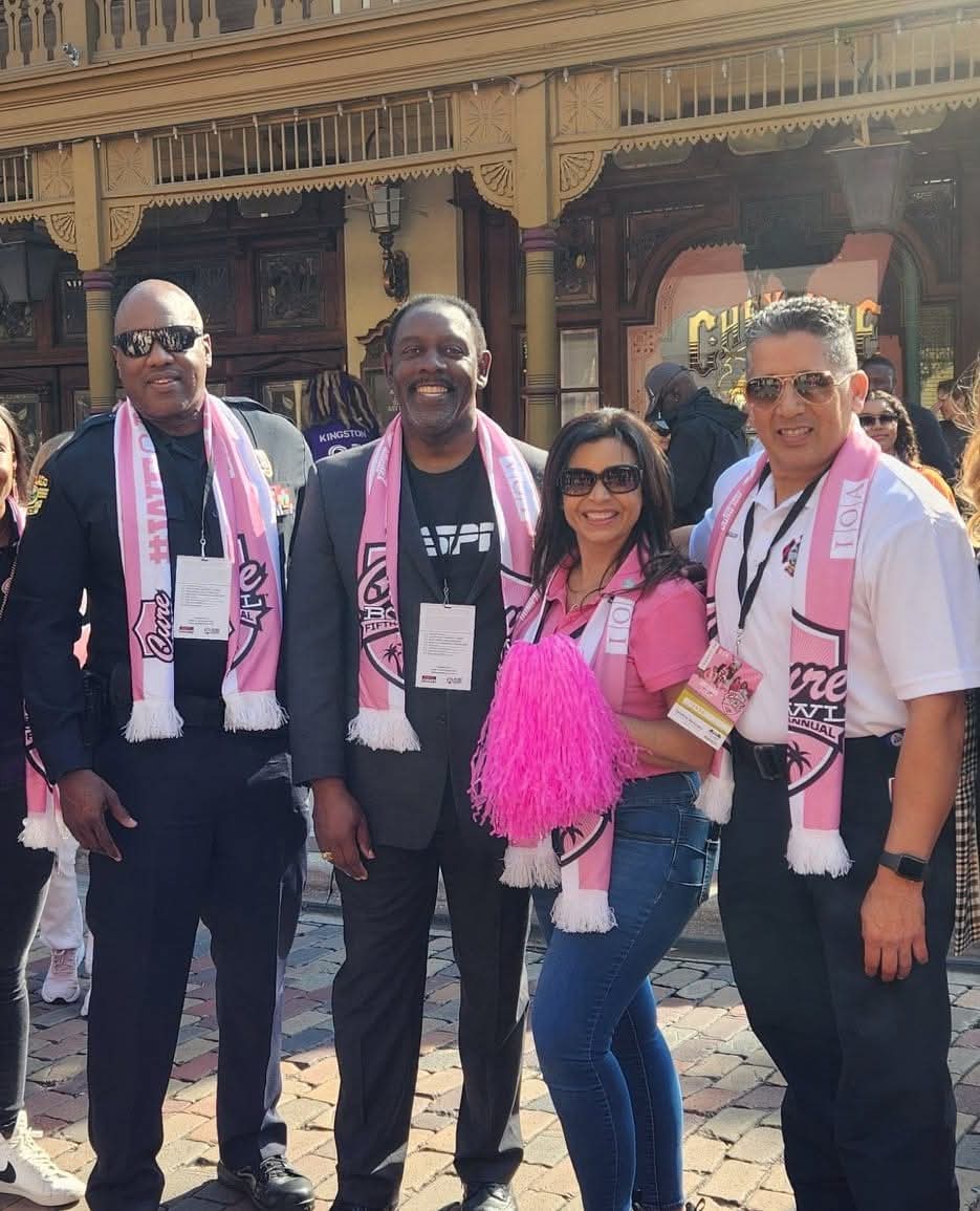 Marthaly with Mayor Jerry Demings and law enforcement at the Cure Bowl